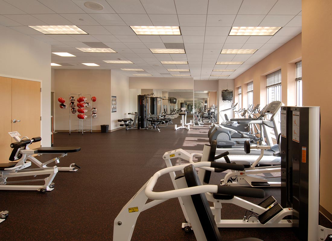 Spacious empty gym with cardio and weight machines